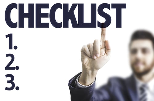 Business man pointing the text Checklist