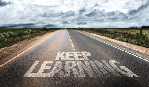 Keep Learning written on rural road