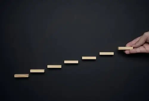 hand-making-wooden-stair-black-background-career-growth-progress-concepts