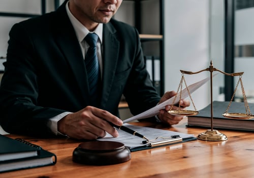 lawyer-working-document-with-scales-justice