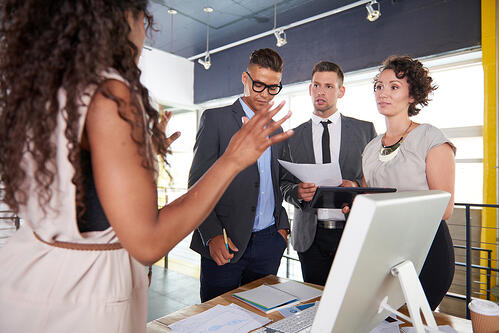 team of successful business people having a meeting in executive sunlit office
